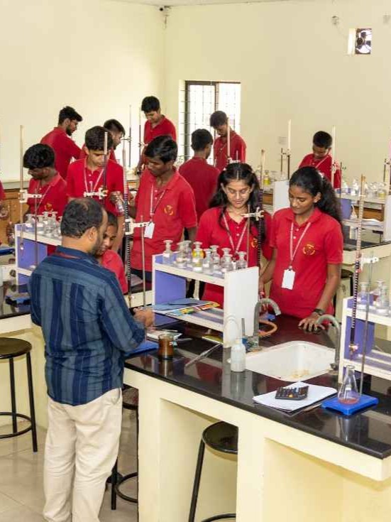 Lecturer guiding a student in the chemistry lab